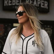 Woman wearing Flair Polarized Sunglasses from Rebel Reaper collection with tattoo flash style