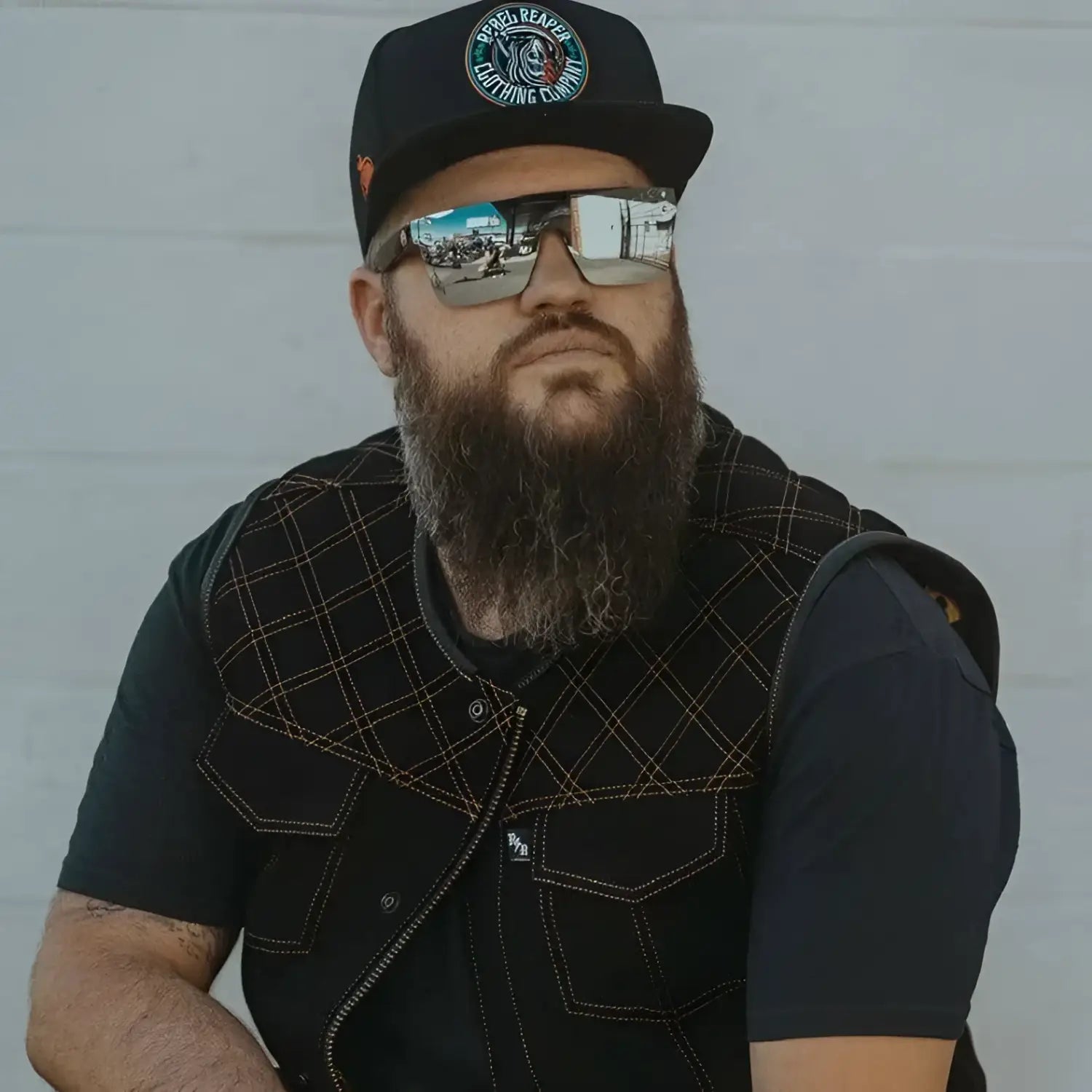 Bearded man wearing Flair Polarized Sunglasses from the Rebel Reaper tattoo flash collection