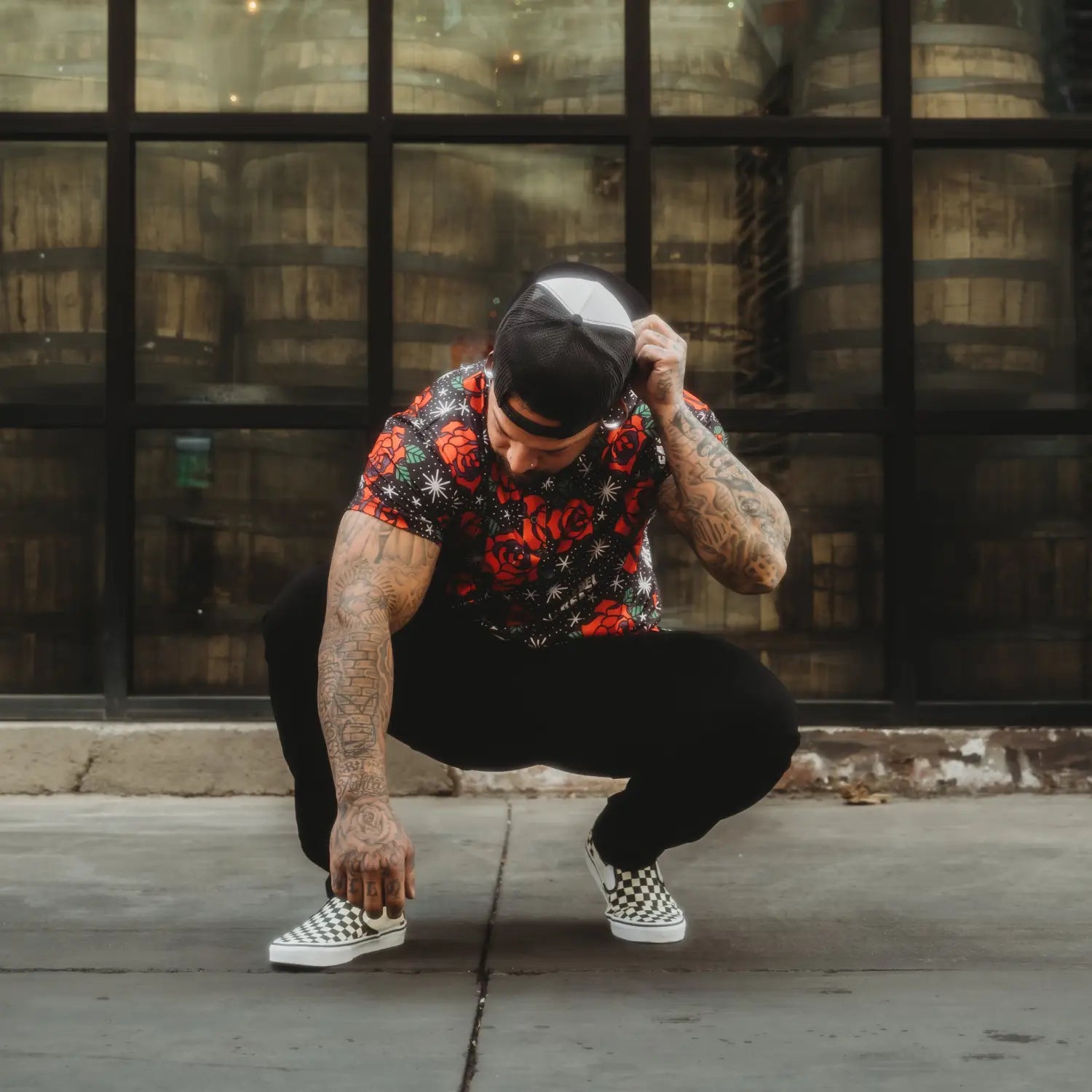 Man in floral shirt and checkered shoes wearing Roses Premium Polo for casual outings