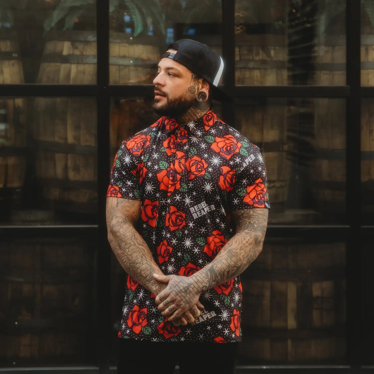 Man wearing a Roses Premium Polo with bold floral design for casual outings