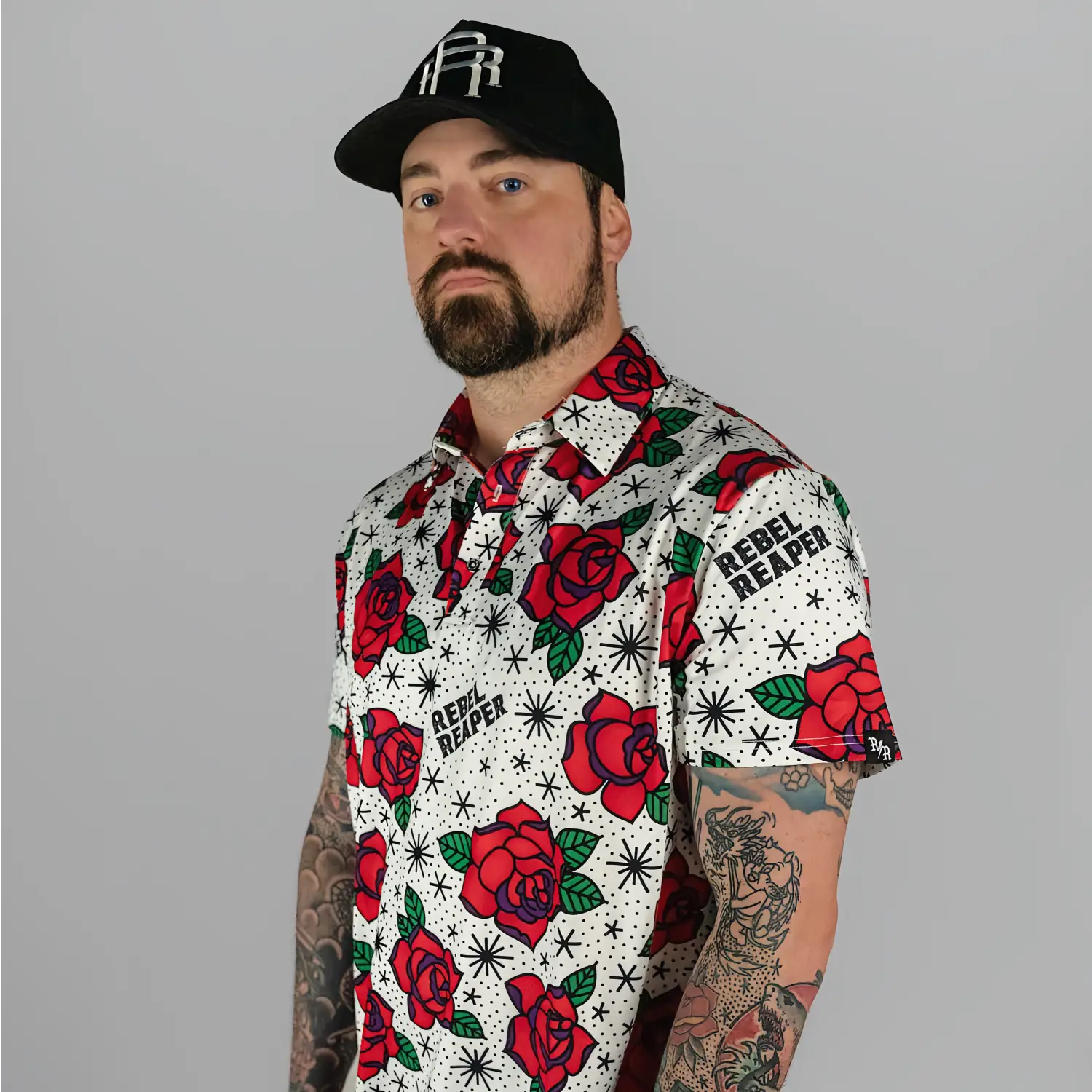 Man in floral shirt and baseball cap wearing Rose’s Premium Polo for casual outings