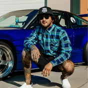 Tattooed man wearing men’s Frostbite Flannel with durable fabric and rebel reaper design