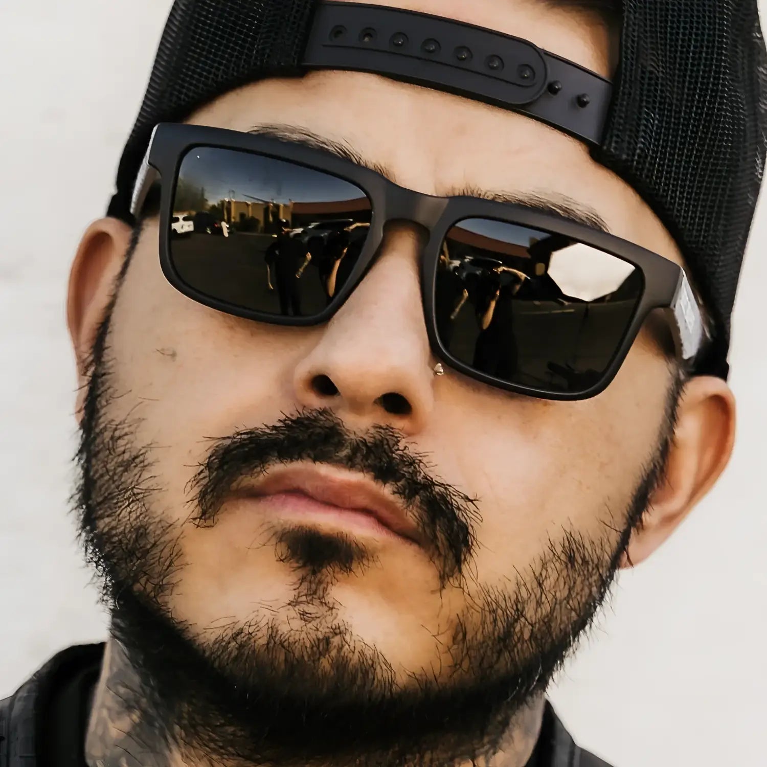 Man wearing sunglasses and a hat from Hustler Wayfarer Sunglass Collection with signature rebel reaper interchangeable arms