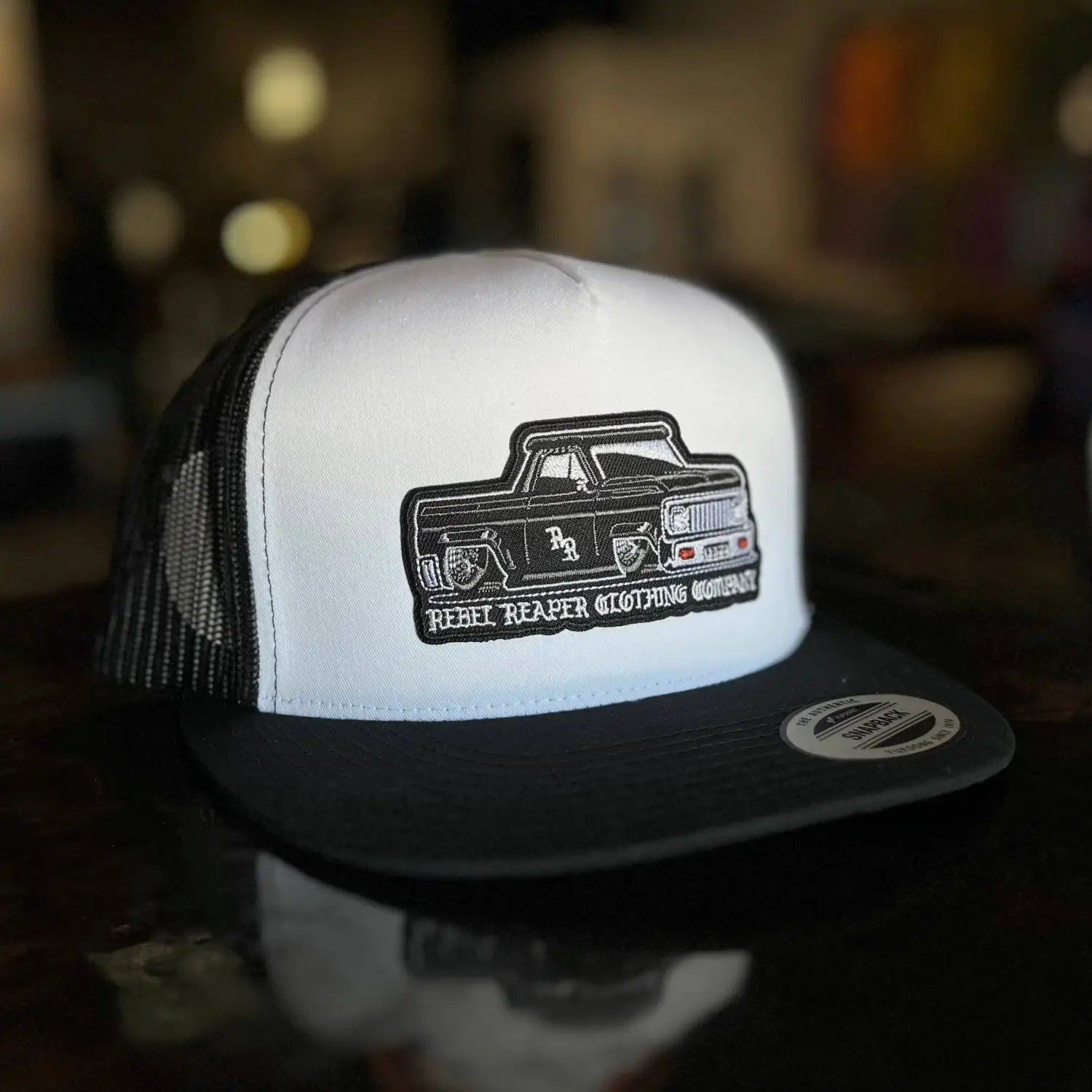 Rebel Reaper lowered truck hat in black and white with mesh panels for a stylish look