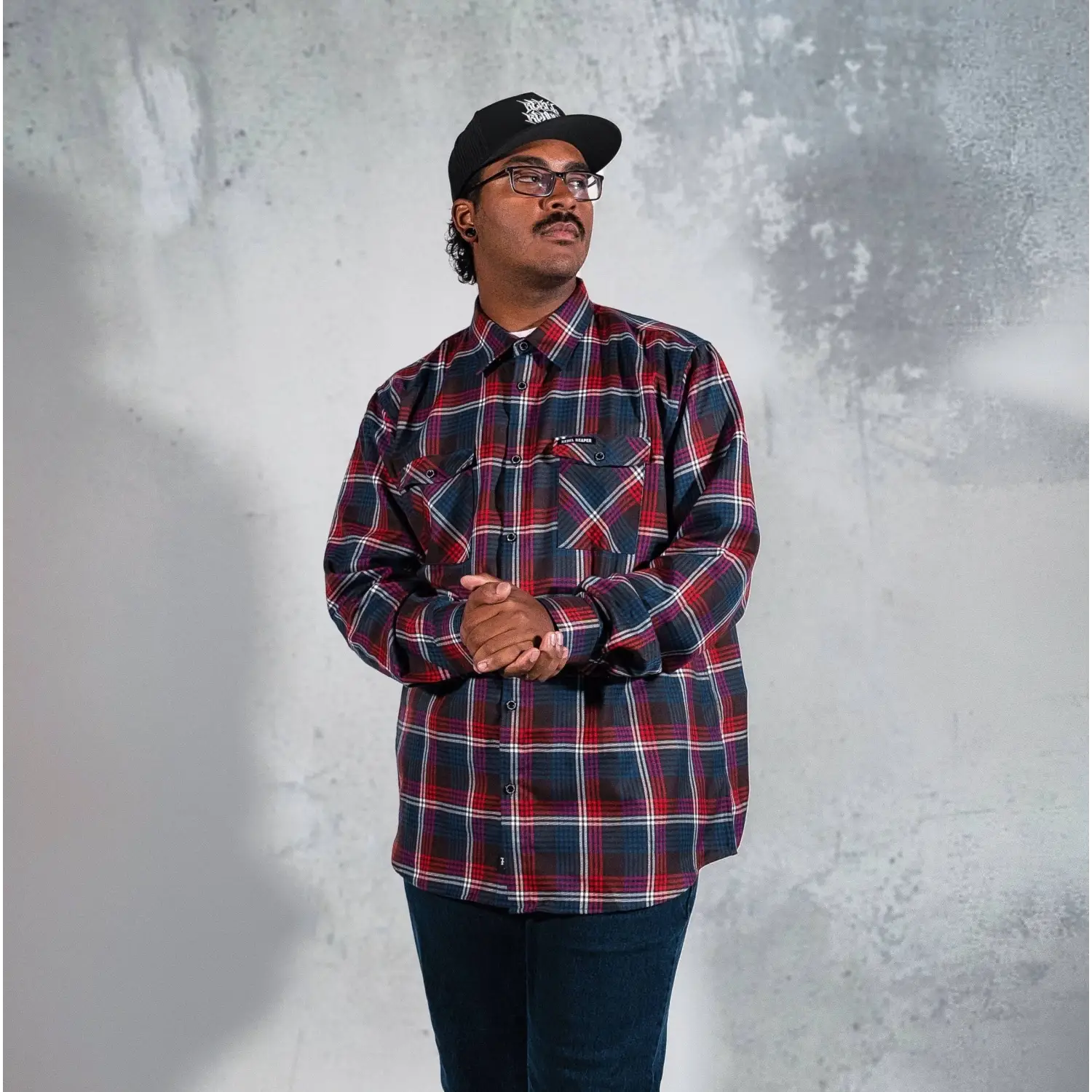 Man in plaid shirt and baseball cap wearing Perserverance Mens Flannel with supreme fabric