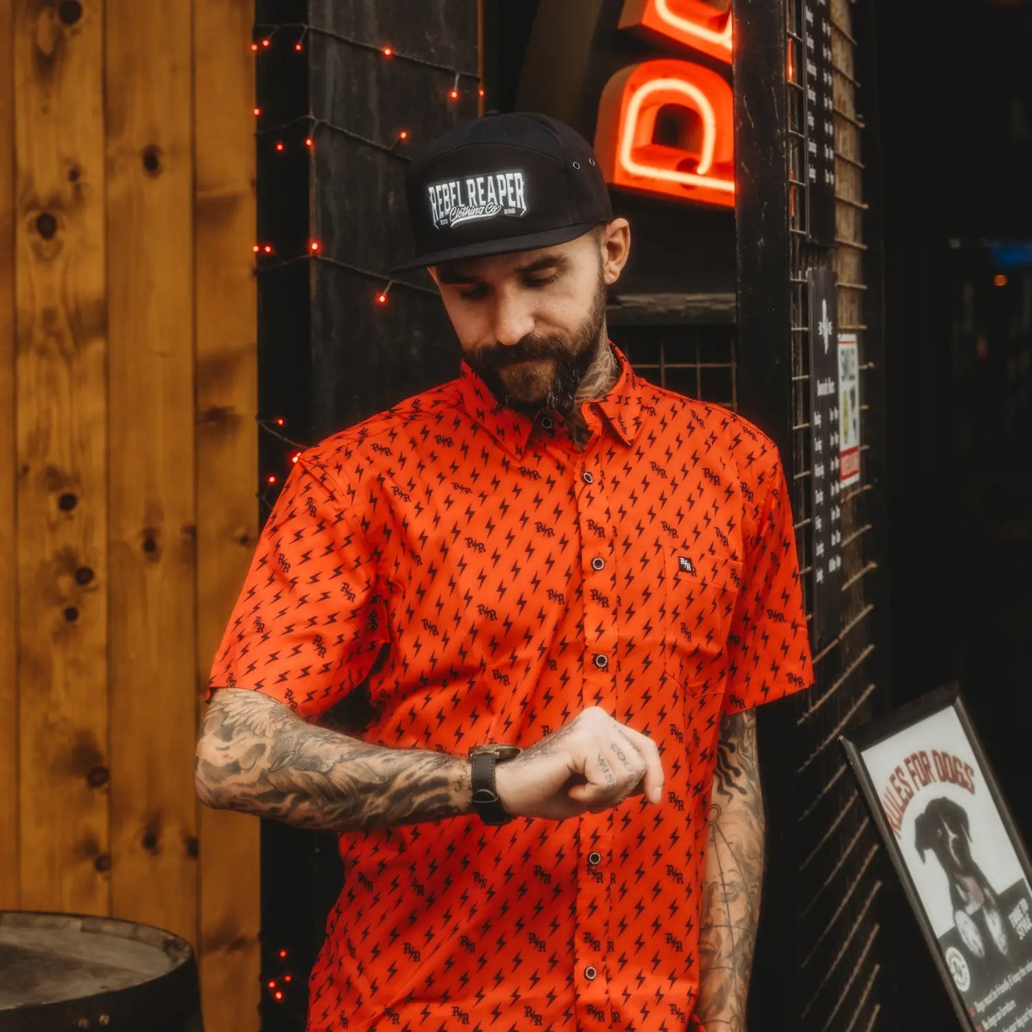 Man in orange lightning bolt shirt featuring iconic bolts and wrinkle-resistant fabric