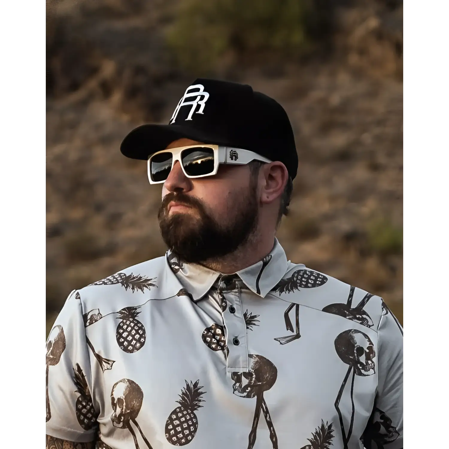 Man wearing Skull and Pineapple shirt from Retro Squared Polarized Sunglass Collection with rebel reaper tattoo