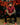 Tattooed man in red shirt and black hat.