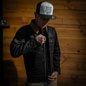 Black jacket with tan collar from The Scythe Jacket Black Denim showcasing premium selvedge denim