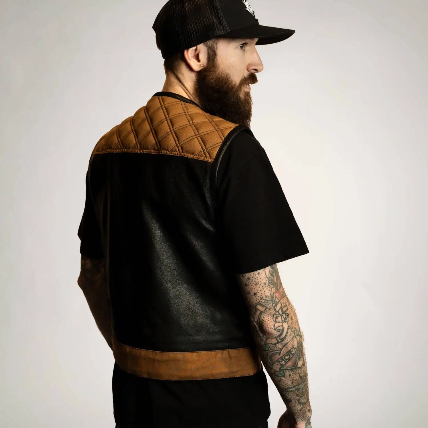 Black and brown cowhide leather vest with concealed carry pockets and double diamond detail