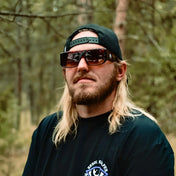 Man wearing Vibe Retro UV400 Sunglasses with Rebel Reaper Monogram and backwards cap