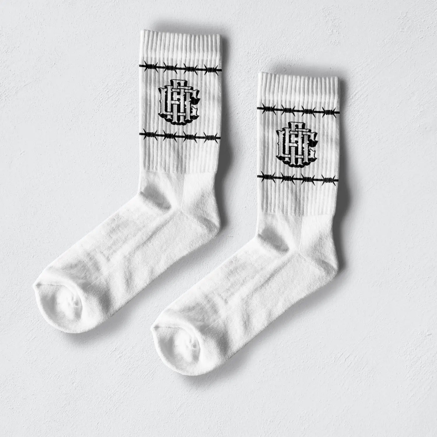 White Barb Wire Crew Socks made from combed cotton, machine washable socks with barbed wire and logo