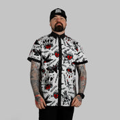 Man in White Rogue Button Up Shirt S/S with rebel reaper tattoo pattern and modern rock style