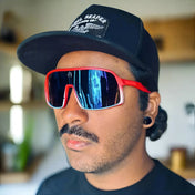 Man wearing Yeti Shield UV400 sunglasses from the Shield UV400 collection with red frames