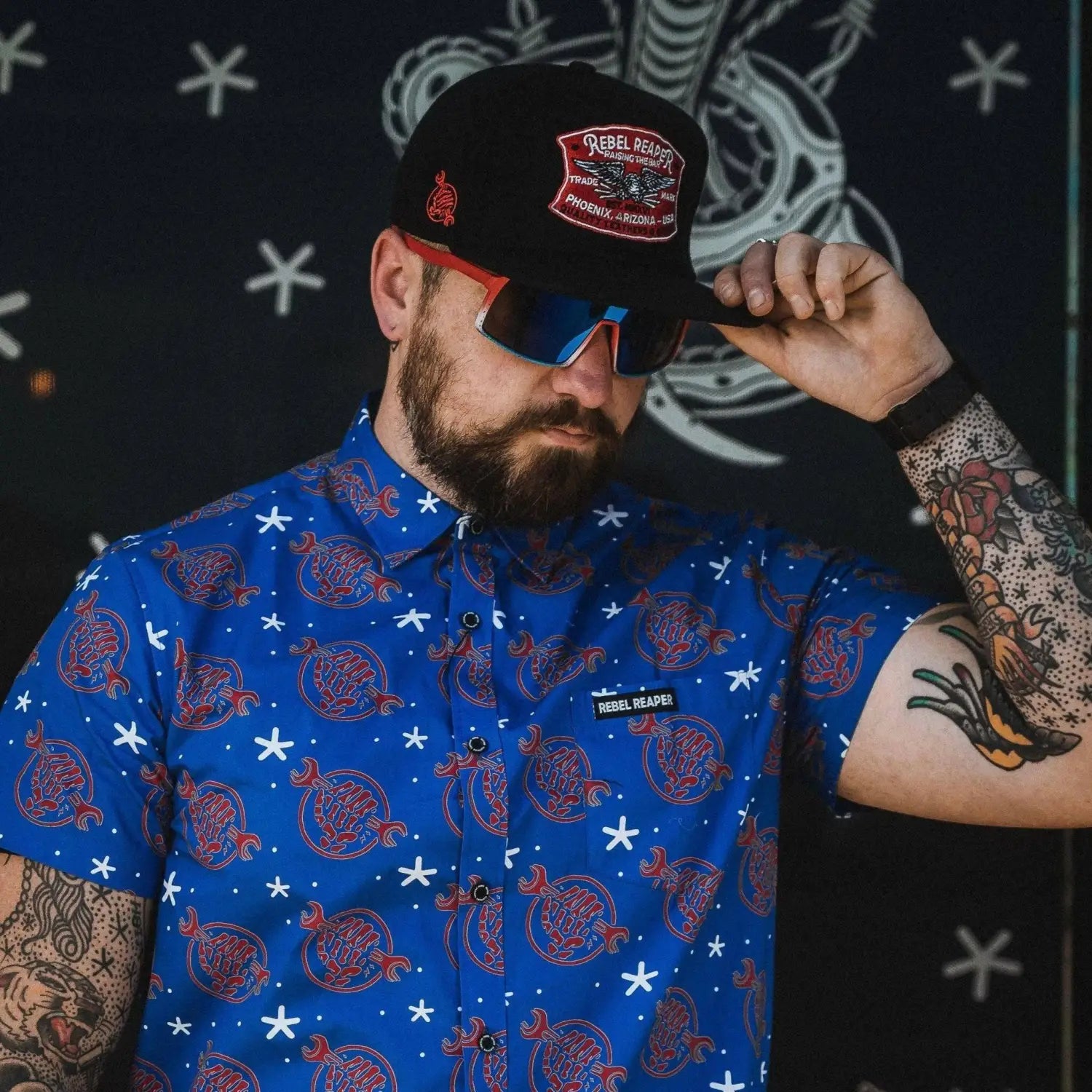 Man in patterned shirt and baseball cap wearing Yeti Shield UV400 sunglasses for legendary protection