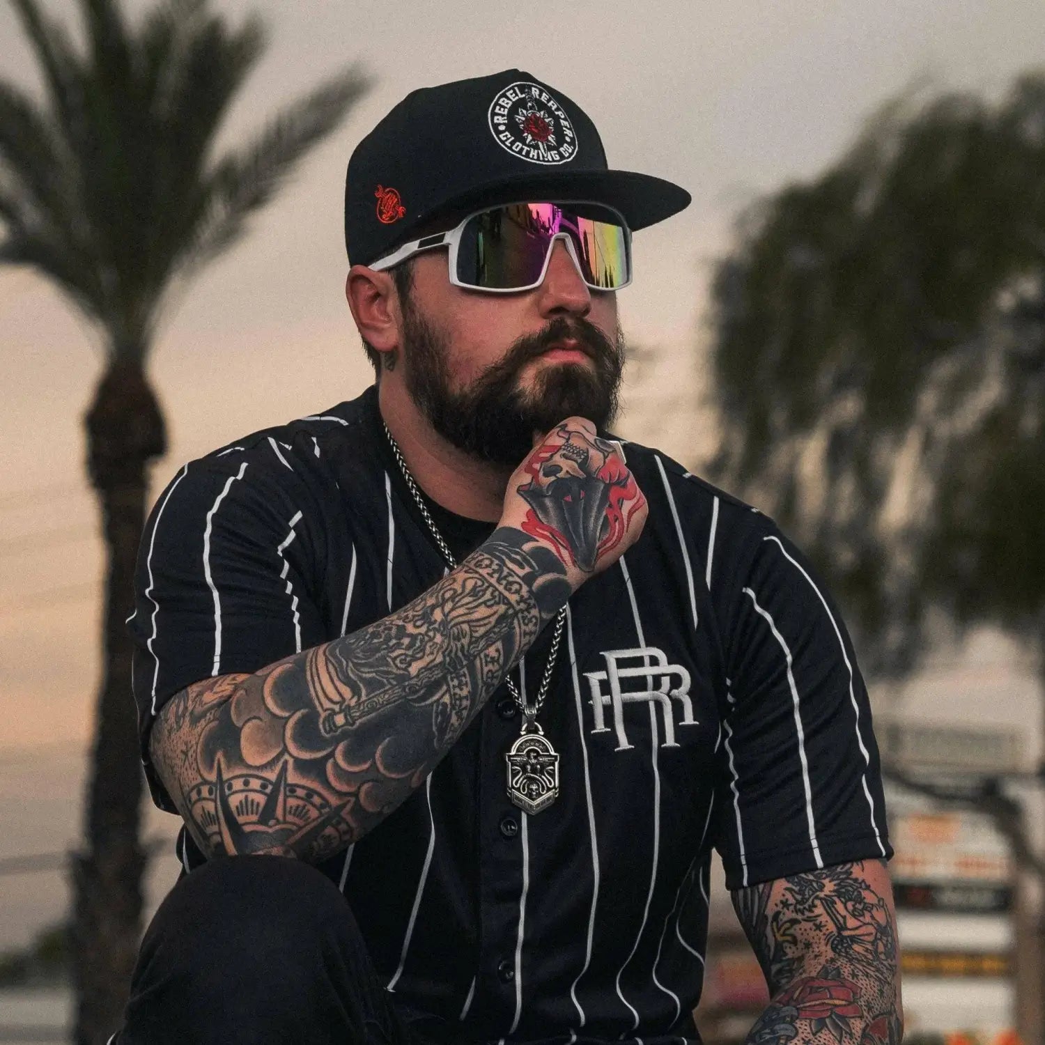 Tattooed man with beard and sunglasses wearing Yeti Shield UV400 sunglasses for legendary protection